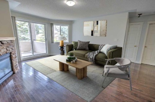 1207-7451 Springbank Boulevard Sw, Calgary, AB - Indoor Photo Showing Living Room With Fireplace