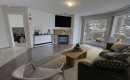 1207-7451 Springbank Boulevard Sw, Calgary, AB  - Indoor Photo Showing Living Room With Fireplace 
