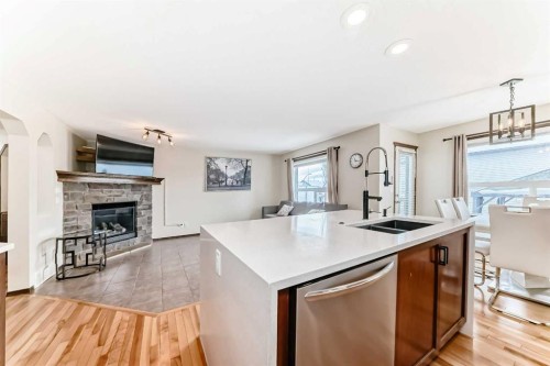 7 Tuscany Ridge Crescent Nw, Calgary, AB - Indoor Photo Showing Kitchen With Fireplace With Double Sink