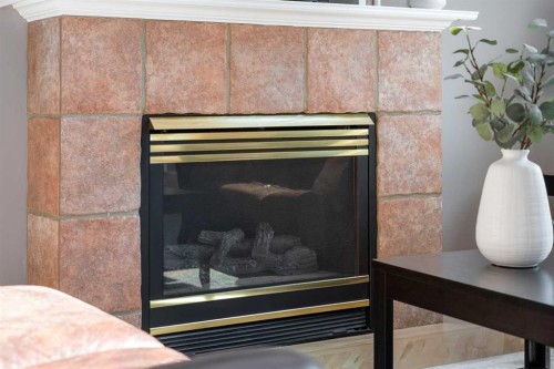 27 Henderson Road Ne, Langdon, AB - Indoor With Fireplace