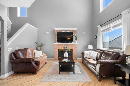 27 Henderson Road Ne, Langdon, AB - Indoor Photo Showing Living Room With Fireplace