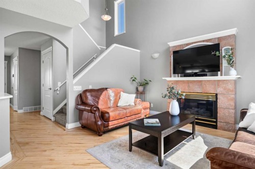 27 Henderson Road Ne, Langdon, AB - Indoor Photo Showing Living Room With Fireplace