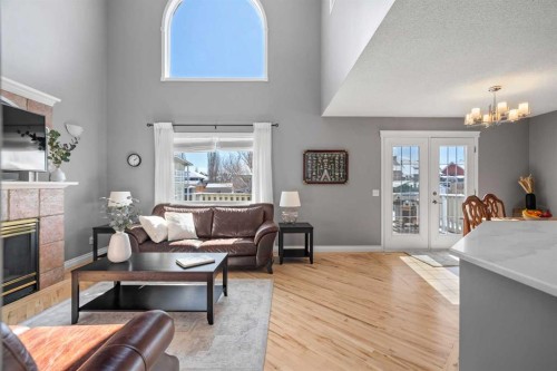 27 Henderson Road Ne, Langdon, AB - Indoor Photo Showing Living Room With Fireplace
