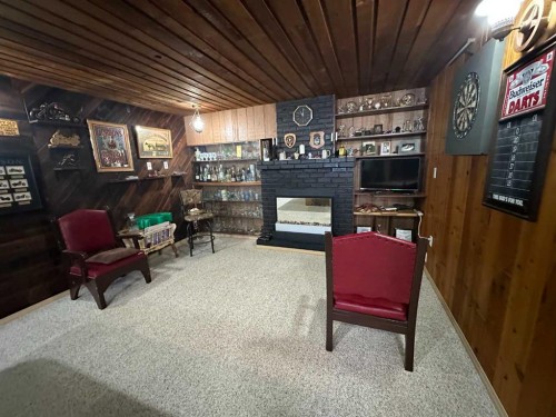 2123 16 Avenue, Didsbury, AB - Indoor Photo Showing Other Room With Fireplace