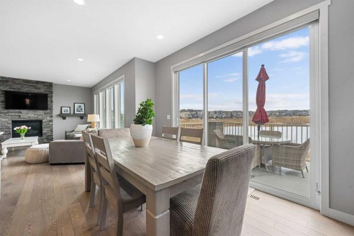 121 Marquis View Se, Calgary, AB - Indoor Photo Showing Dining Room With Fireplace