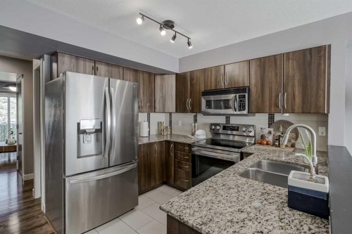 10 Chaparral Ridge Park Se, Calgary, AB - Indoor Photo Showing Kitchen With Stainless Steel Kitchen With Double Sink