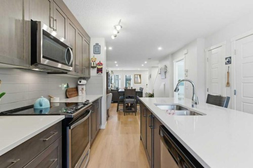 410-338 Seton Circle Se, Calgary, AB - Indoor Photo Showing Kitchen With Double Sink With Upgraded Kitchen