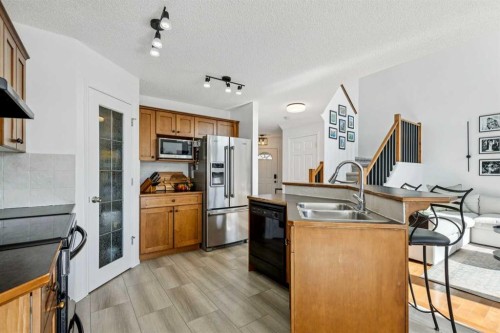 214 Cougarstone Circle Sw, Calgary, AB - Indoor Photo Showing Kitchen With Double Sink