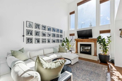 214 Cougarstone Circle Sw, Calgary, AB - Indoor Photo Showing Living Room With Fireplace