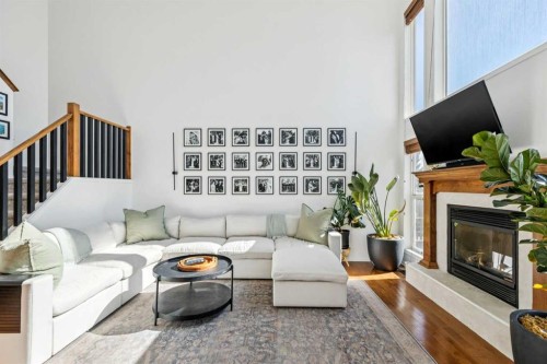 214 Cougarstone Circle Sw, Calgary, AB - Indoor Photo Showing Living Room With Fireplace