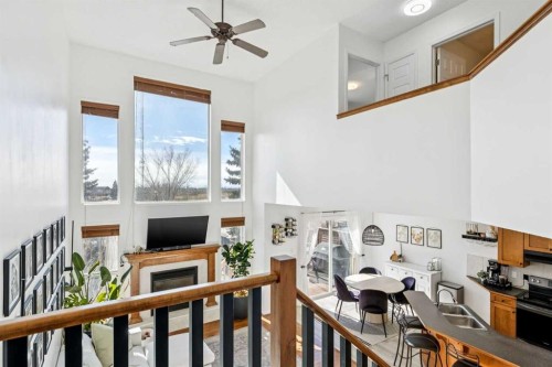 214 Cougarstone Circle Sw, Calgary, AB - Indoor Photo Showing Other Room With Fireplace