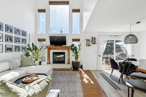 214 Cougarstone Circle Sw, Calgary, AB - Indoor Photo Showing Living Room With Fireplace