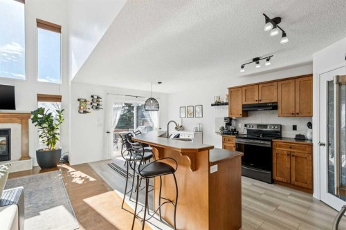 214 Cougarstone Circle Sw, Calgary, AB - Indoor Photo Showing Other Room With Fireplace