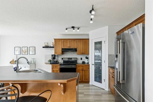 214 Cougarstone Circle Sw, Calgary, AB - Indoor Photo Showing Kitchen With Double Sink