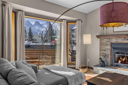 100 Settler Way, Canmore, AB - Indoor Photo Showing Living Room With Fireplace