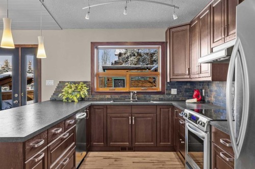 100 Settler Way, Canmore, AB - Indoor Photo Showing Kitchen With Double Sink