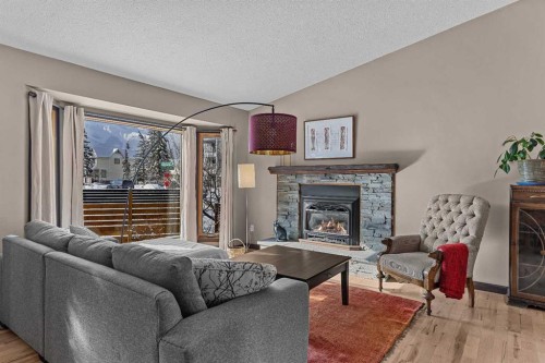 100 Settler Way, Canmore, AB - Indoor Photo Showing Living Room With Fireplace