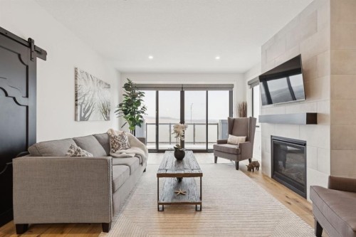 220 Precedence View, Cochrane, AB - Indoor Photo Showing Living Room With Fireplace