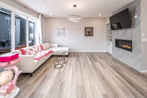 148 Carringham Road Nw, Calgary, AB - Indoor Photo Showing Living Room With Fireplace