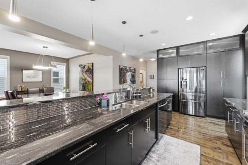 95 Sunset Way, Cochrane, AB - Indoor Photo Showing Kitchen With Double Sink With Upgraded Kitchen