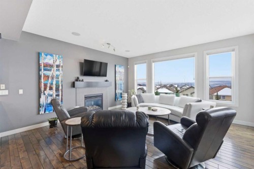 95 Sunset Way, Cochrane, AB - Indoor Photo Showing Living Room With Fireplace