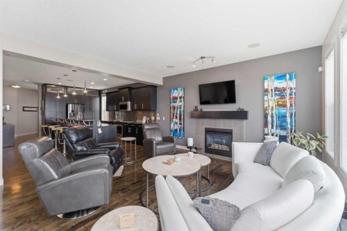 95 Sunset Way, Cochrane, AB - Indoor Photo Showing Living Room With Fireplace