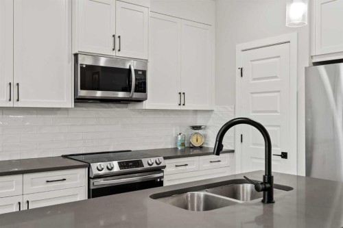 182 River Heights Drive, Cochrane, AB - Indoor Photo Showing Kitchen With Stainless Steel Kitchen With Double Sink With Upgraded Kitchen