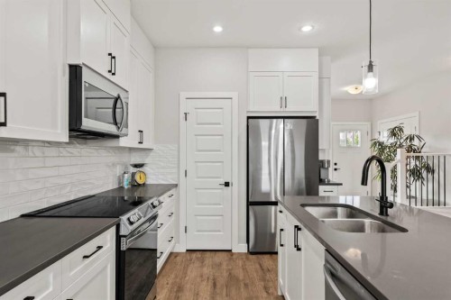 182 River Heights Drive, Cochrane, AB - Indoor Photo Showing Kitchen With Stainless Steel Kitchen With Double Sink With Upgraded Kitchen