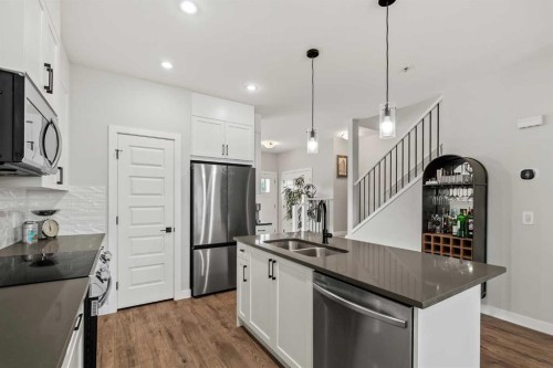 182 River Heights Drive, Cochrane, AB - Indoor Photo Showing Kitchen With Stainless Steel Kitchen With Double Sink With Upgraded Kitchen