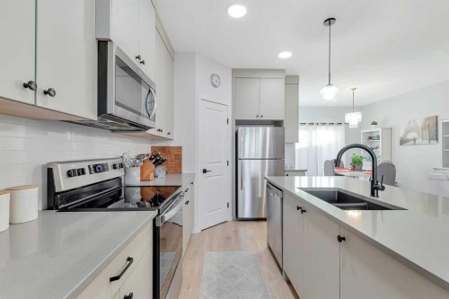 371 Fireside Way, Cochrane, AB - Indoor Photo Showing Kitchen With Stainless Steel Kitchen With Double Sink With Upgraded Kitchen