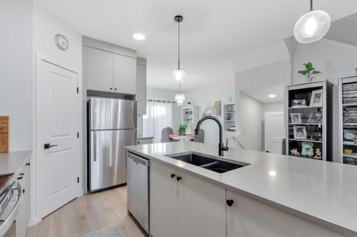 371 Fireside Way, Cochrane, AB - Indoor Photo Showing Kitchen With Stainless Steel Kitchen With Double Sink With Upgraded Kitchen