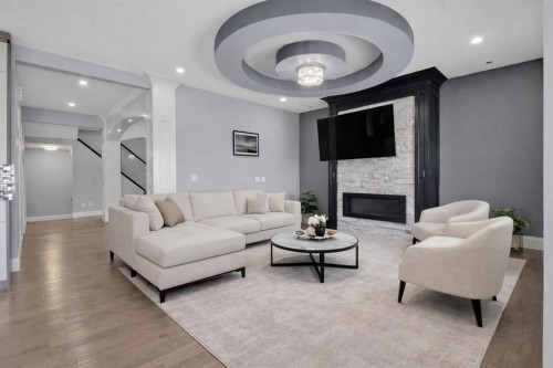 302 Kinniburgh Rd, Chestermere, AB - Indoor Photo Showing Living Room With Fireplace