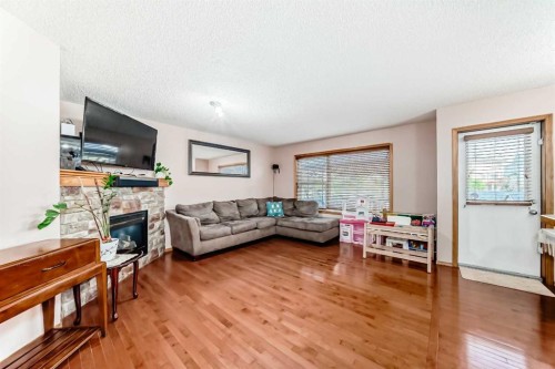 16062 Everstone Road Sw, Calgary, AB - Indoor Photo Showing Living Room With Fireplace