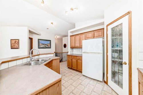 220 Rocky Ridge Villas Nw, Calgary, AB - Indoor Photo Showing Kitchen With Double Sink