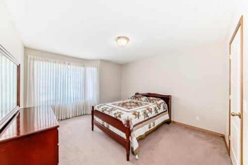 220 Rocky Ridge Villas Nw, Calgary, AB - Indoor Photo Showing Bedroom