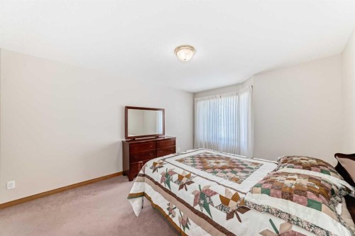 220 Rocky Ridge Villas Nw, Calgary, AB - Indoor Photo Showing Bedroom