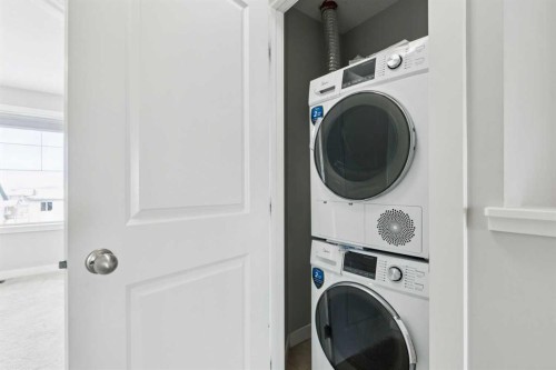 2506 Jumping Pound Common, Cochrane, AB - Indoor Photo Showing Laundry Room