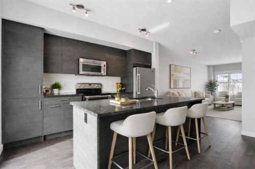 2506 Jumping Pound Common, Cochrane, AB - Indoor Photo Showing Kitchen With Stainless Steel Kitchen With Double Sink With Upgraded Kitchen