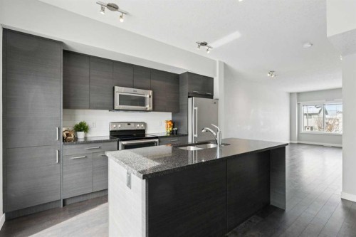 2506 Jumping Pound Common, Cochrane, AB - Indoor Photo Showing Kitchen With Stainless Steel Kitchen With Double Sink With Upgraded Kitchen