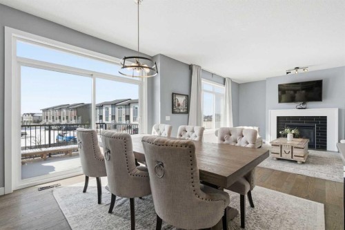 12 Ranchers Bay, Okotoks, AB - Indoor Photo Showing Dining Room With Fireplace