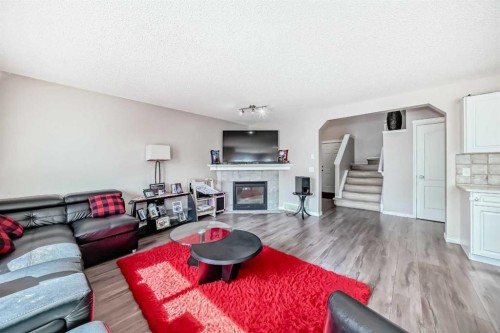 9 Somerside Crescent Sw, Calgary, AB - Indoor Photo Showing Living Room With Fireplace