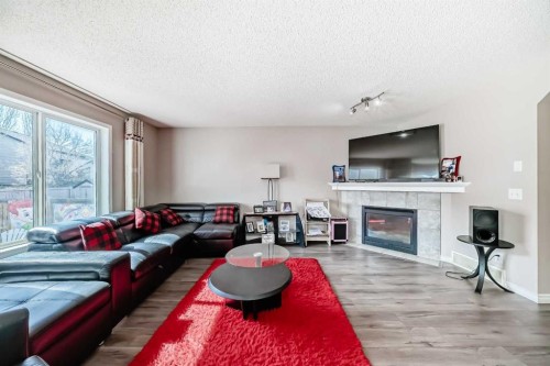 9 Somerside Crescent Sw, Calgary, AB - Indoor Photo Showing Living Room With Fireplace