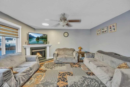 107 Taracove Landing Ne, Calgary, AB - Indoor Photo Showing Living Room With Fireplace