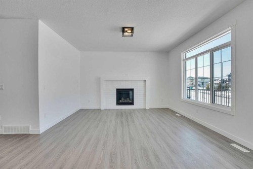 230 Kinniburgh Loop, Chestermere, AB - Indoor Photo Showing Living Room With Fireplace