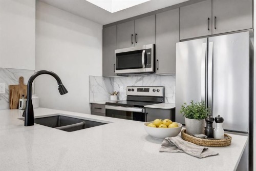 407-140 Mahogany Street, Calgary, AB - Indoor Photo Showing Kitchen With Stainless Steel Kitchen With Double Sink With Upgraded Kitchen