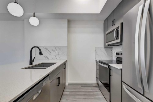 407-140 Mahogany Street, Calgary, AB - Indoor Photo Showing Kitchen With Stainless Steel Kitchen With Double Sink