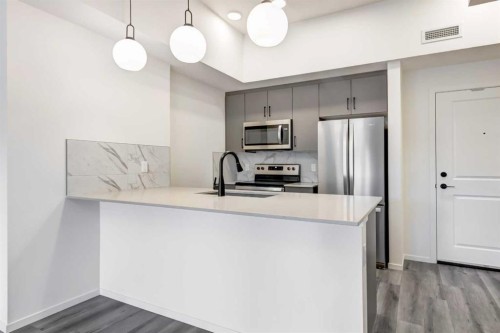 407-140 Mahogany Street, Calgary, AB - Indoor Photo Showing Kitchen With Stainless Steel Kitchen