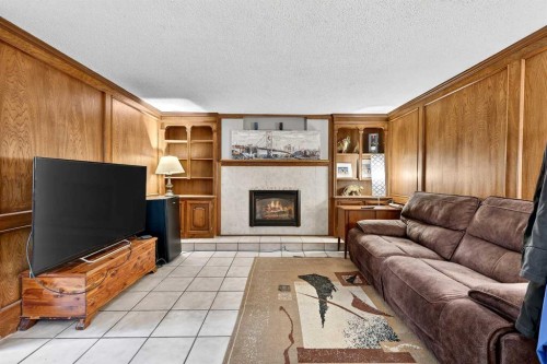 319 Whitney Crescent Se, Calgary, AB - Indoor Photo Showing Living Room With Fireplace