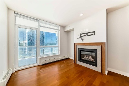1126-222 Riverfront Avenue Sw, Calgary, AB - Indoor Photo Showing Living Room With Fireplace