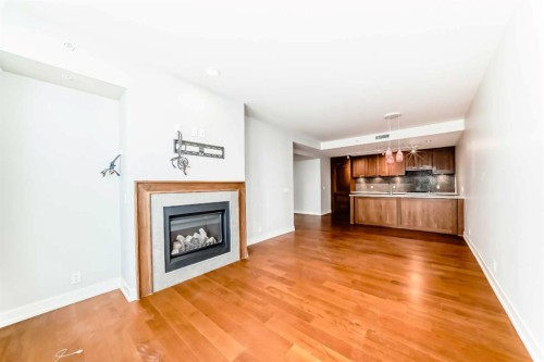 1126-222 Riverfront Avenue Sw, Calgary, AB - Indoor Photo Showing Living Room With Fireplace